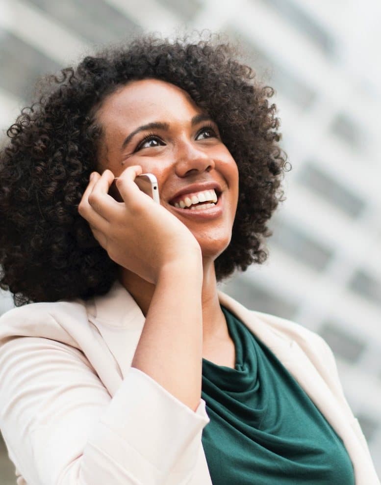 A customer smiling on a phone call